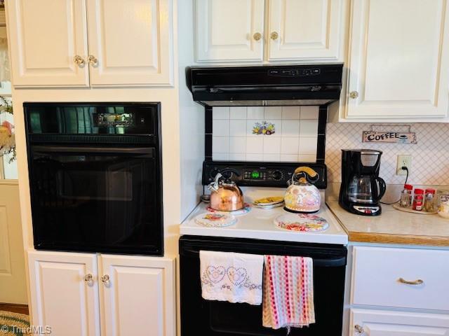 526 Bob Rainey Trl, Burlington, NC 27217 - kitchen with electric range, black oven, exhaust hood, white cabinetry, and decorative backsplash