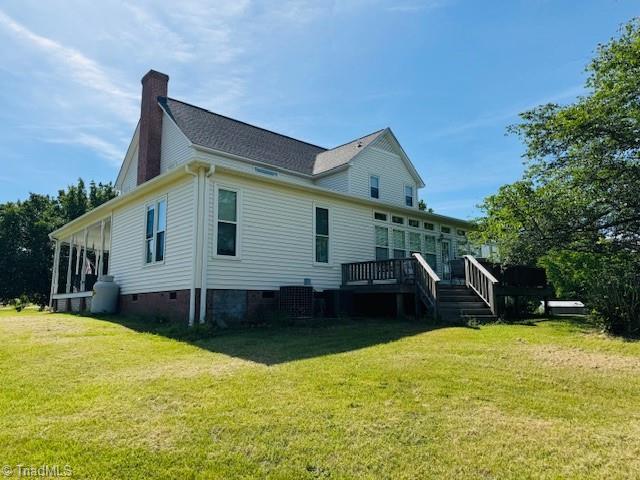 526 Bob Rainey Trl, Burlington, NC 27217 - back of house with a lawn, crawl space, a chimney, a deck, and central AC