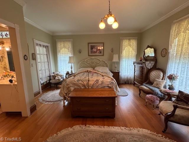 526 Bob Rainey Trl, Burlington, NC 27217 - bedroom with wood finished floors, crown molding, and baseboards