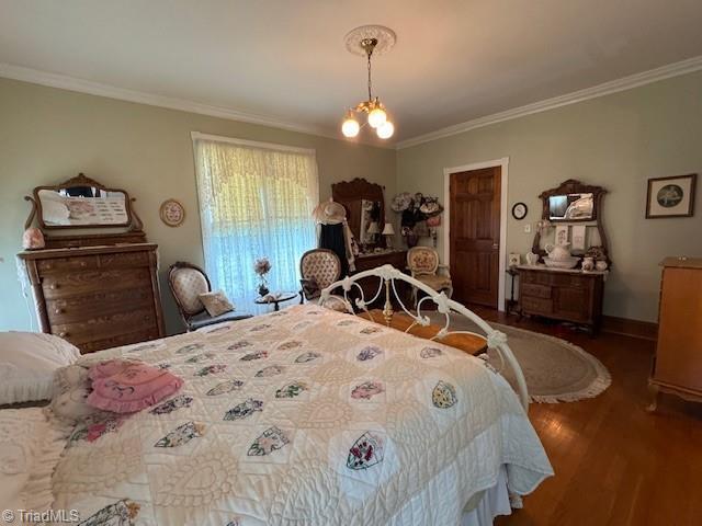 526 Bob Rainey Trl, Burlington, NC 27217 - bedroom with crown molding, wood finished floors, and baseboards