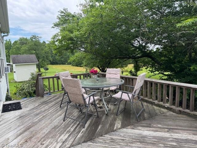 526 Bob Rainey Trl, Burlington, NC 27217 - wooden terrace featuring outdoor dining area and view of wooded area