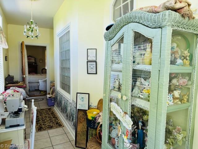 526 Bob Rainey Trl, Burlington, NC 27217 - hall with tile patterned flooring, a chandelier, and plenty of natural light
