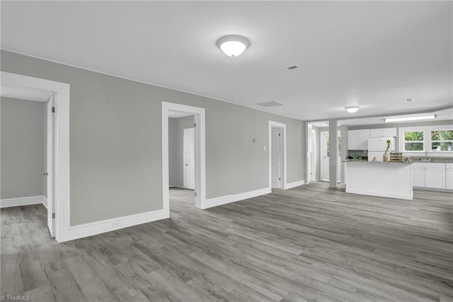 unfurnished living room with light hardwood / wood-style flooring