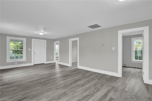 unfurnished living room with light hardwood / wood-style floors and plenty of natural light