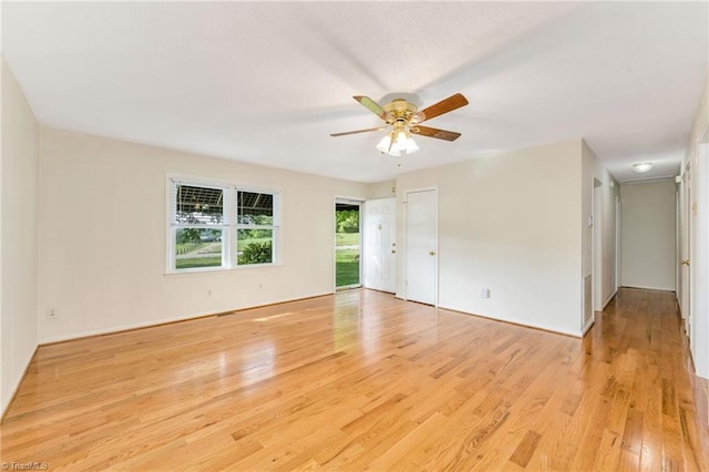 unfurnished room with light wood-style flooring, baseboards, and ceiling fan