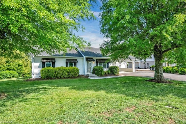 obstructed view of property with a front lawn and driveway