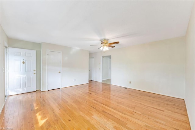 unfurnished room with baseboards, light wood-style floors, and ceiling fan