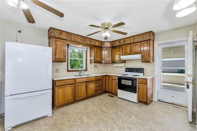 kitchen featuring freestanding refrigerator, a ceiling fan, range with electric stovetop, and under cabinet range hood