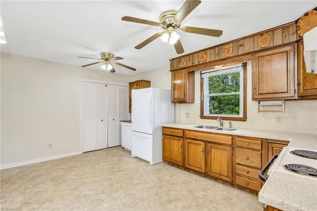 kitchen with white appliances, ceiling fan, a sink, brown cabinets, and light countertops