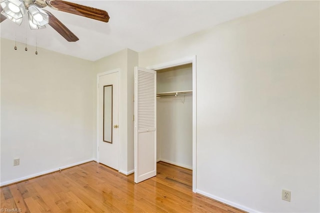 unfurnished bedroom with a closet, a ceiling fan, light wood-style flooring, and baseboards