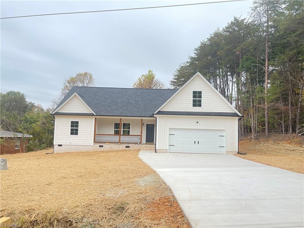 view of front of property with a porch and a garage