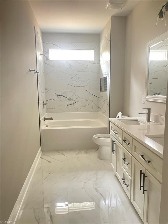 full bathroom featuring tiled shower / bath, vanity, and toilet