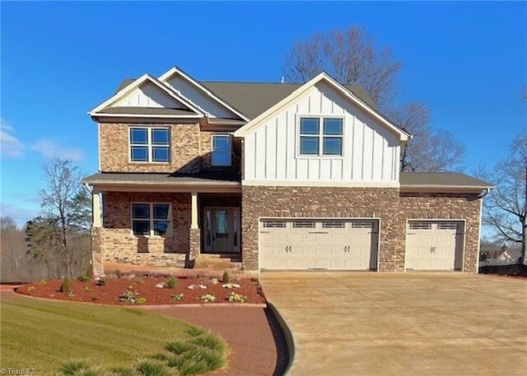 craftsman-style house featuring a garage, a porch, and a front yard