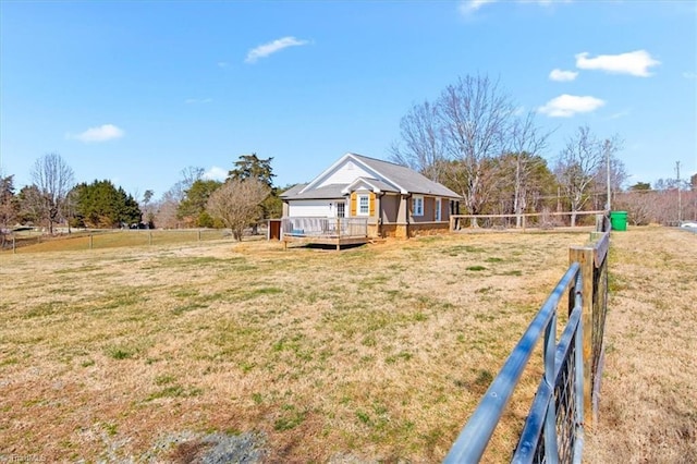 exterior space with fence and a deck