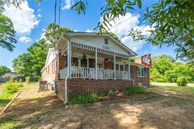 bungalow-style home with cooling unit and covered porch