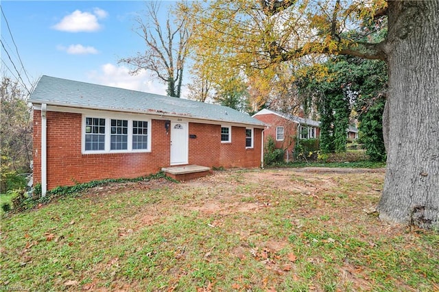 rear view of property with a lawn