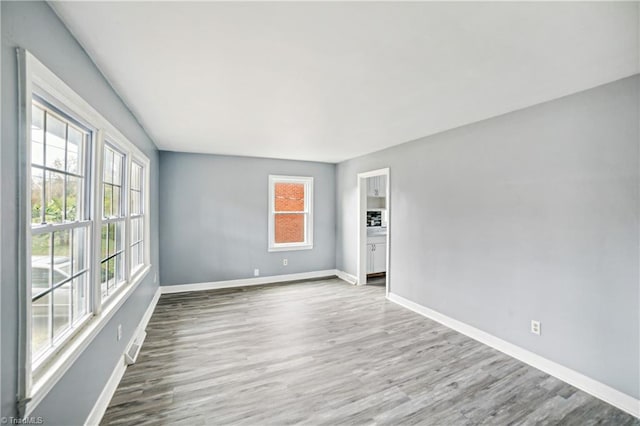 spare room with wood-type flooring