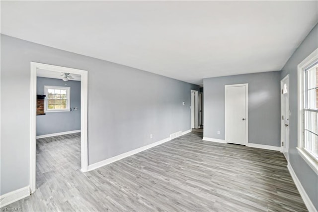 unfurnished room featuring light hardwood / wood-style flooring and ceiling fan