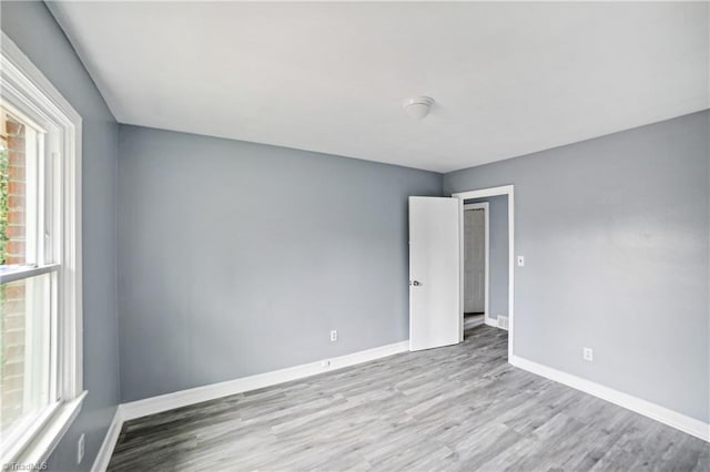 empty room with light hardwood / wood-style floors