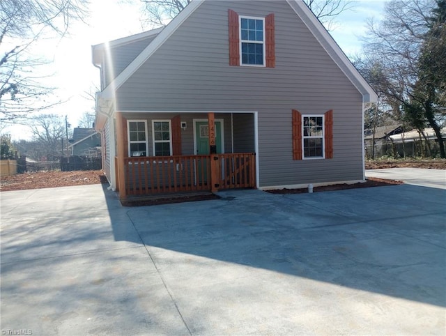 rear view of house featuring a porch