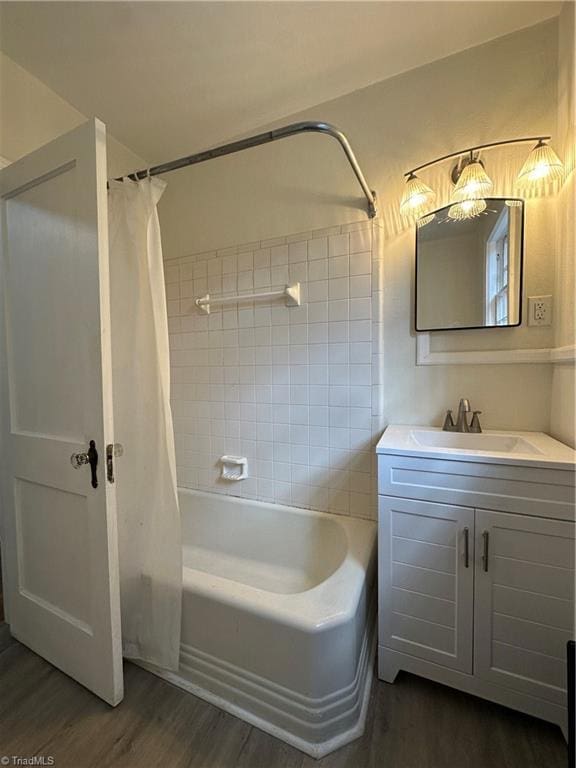 bathroom with vanity, wood finished floors, and shower / tub combo with curtain