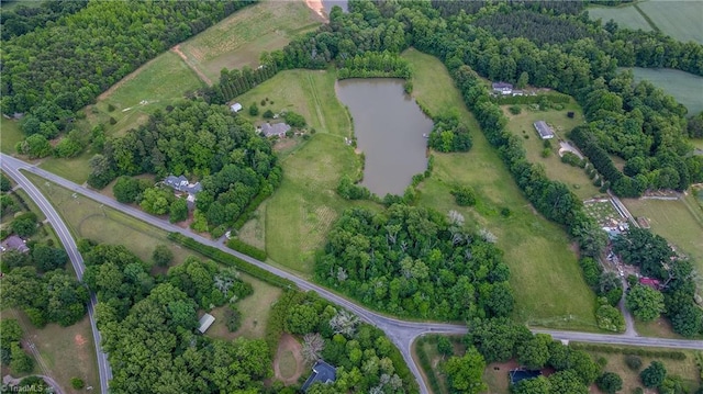 aerial view of property and surrounding area featuring a nearby body of water and rural landscape