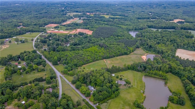 aerial view of property's location with a large body of water and a forest