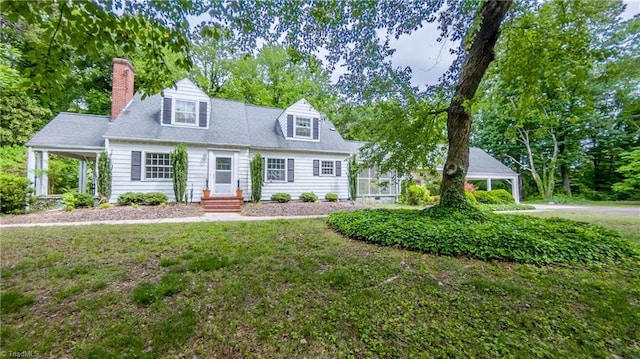 cape cod-style house featuring a chimney, a front lawn, and entry steps