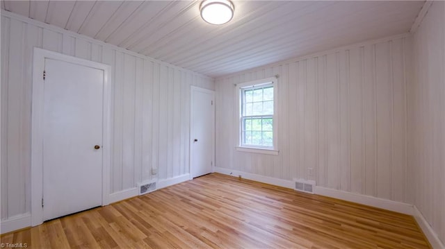 unfurnished room with light wood-type flooring