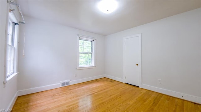 unfurnished room featuring light wood-style floors and baseboards