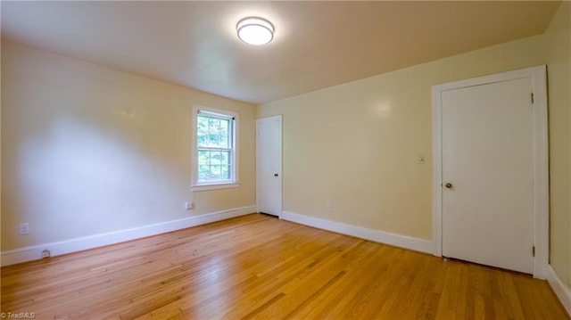 unfurnished room featuring light wood-style floors and baseboards