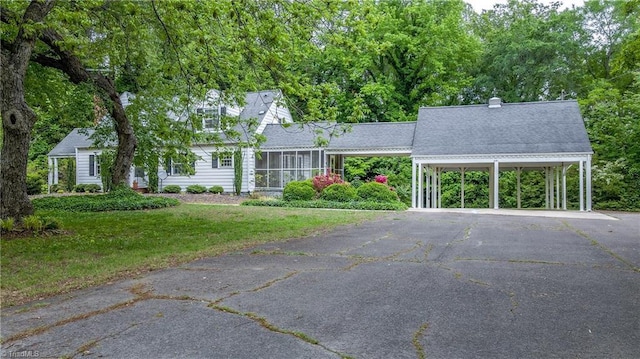 cape cod-style house with driveway and a front yard