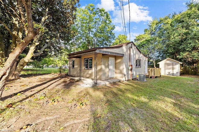 view of home's exterior with a yard and a storage shed