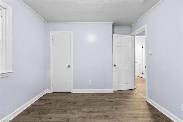 unfurnished bedroom with ornamental molding and wood-type flooring