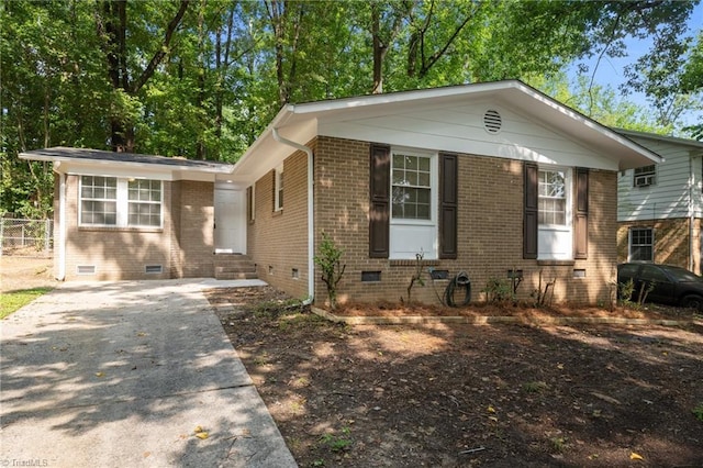 2315 Regency Dr, Greensboro, NC 27407 - view of front of home featuring crawl space, entry steps, brick siding, and driveway