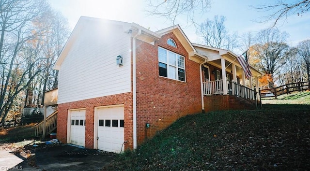 view of property exterior with a garage and a porch