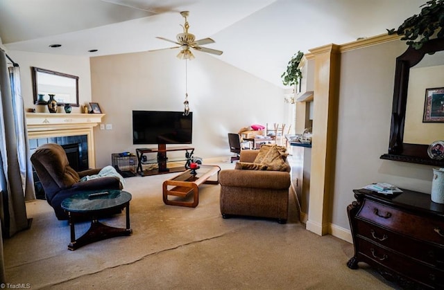 living room with a tiled fireplace, vaulted ceiling, light colored carpet, and ceiling fan