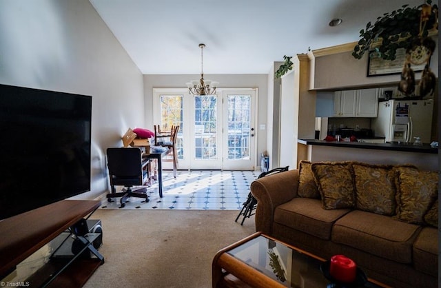 carpeted living room with a chandelier and vaulted ceiling