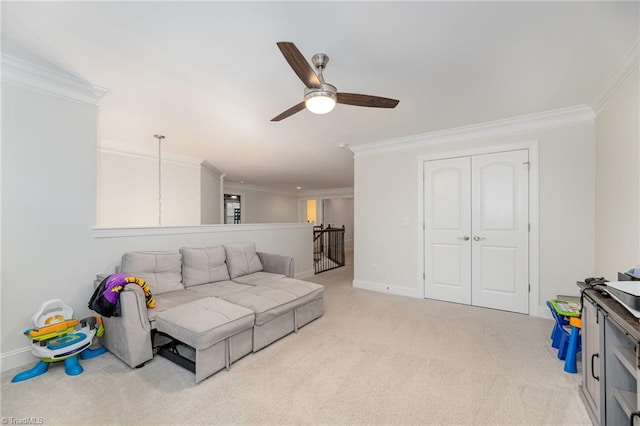 carpeted living room with ornamental molding and ceiling fan