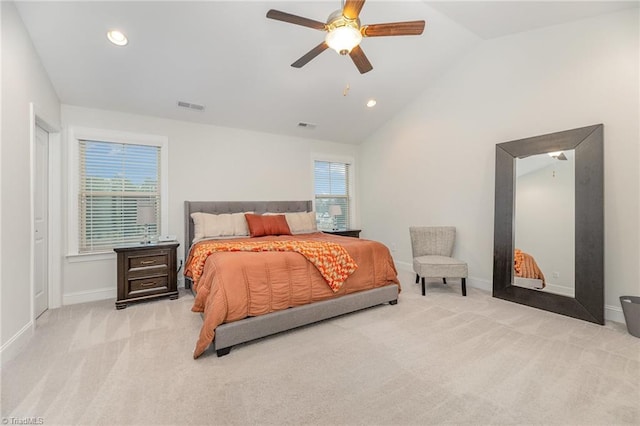 bedroom featuring light carpet, lofted ceiling, and ceiling fan