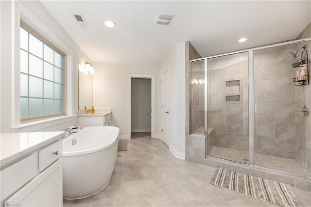 bathroom featuring vanity and independent shower and bath