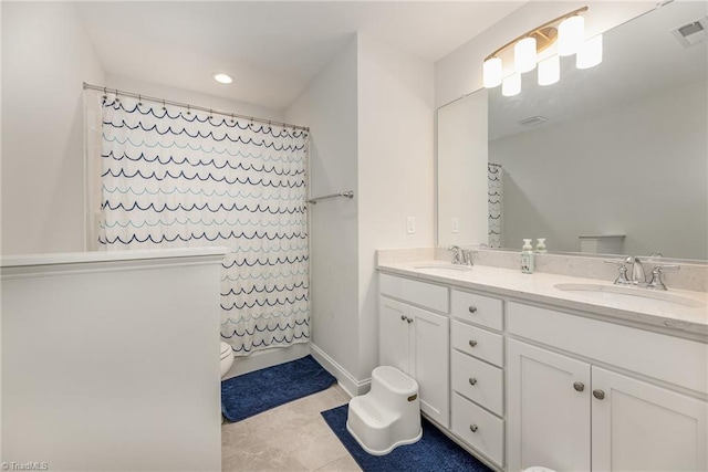 bathroom featuring vanity, a shower with shower curtain, tile patterned floors, and toilet