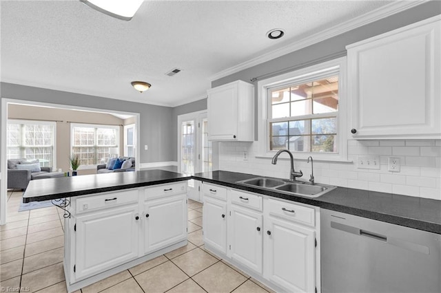 kitchen featuring stainless steel dishwasher, plenty of natural light, open floor plan, and a sink