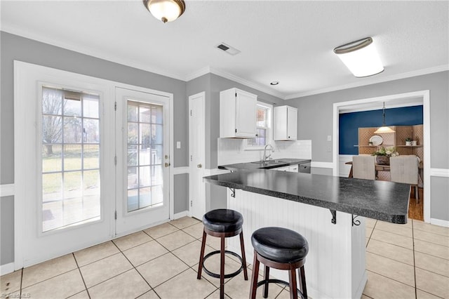 kitchen featuring light tile patterned floors, visible vents, and plenty of natural light