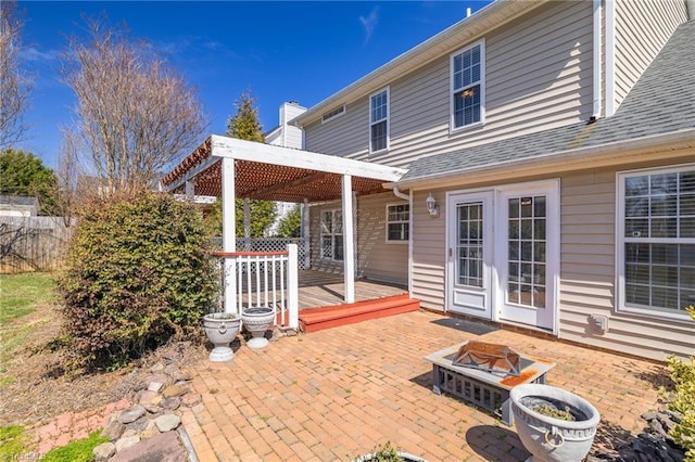 view of patio / terrace featuring an outdoor fire pit, a deck, and fence