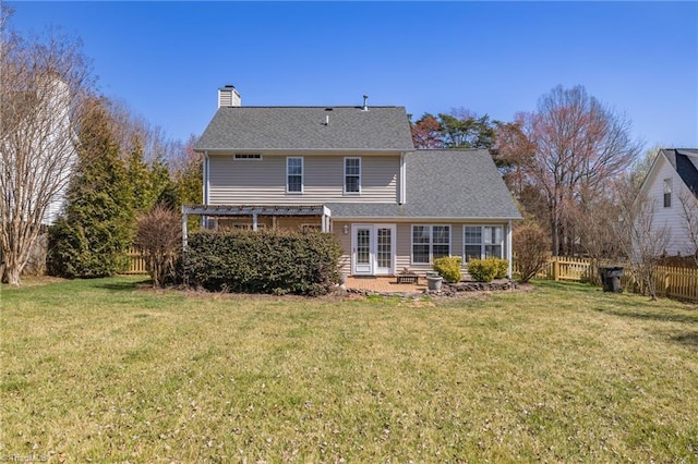 back of house with french doors, a chimney, a yard, and fence