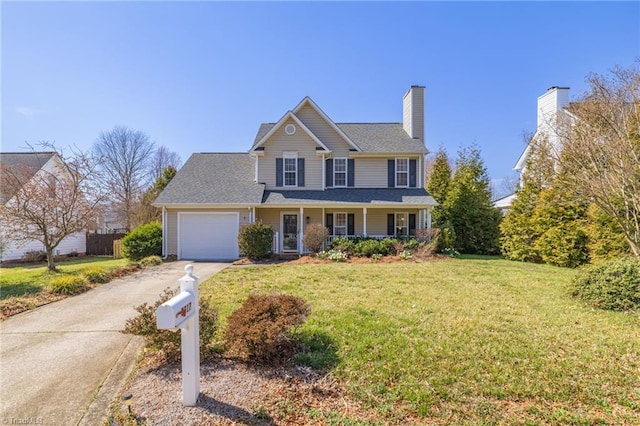 view of front facade with a front yard, covered porch, a chimney, a garage, and driveway