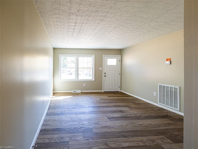 entrance foyer featuring a textured ceiling and dark hardwood / wood-style floors