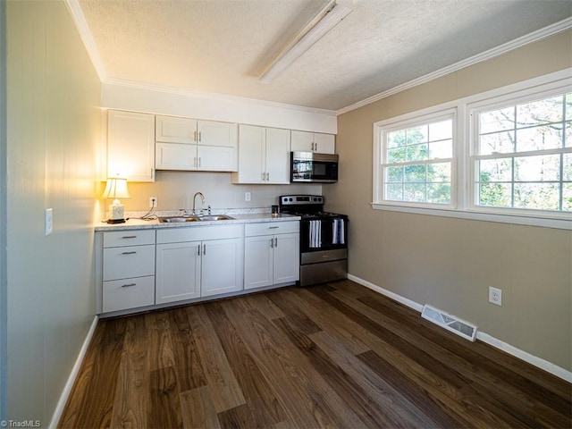 kitchen with sink, dark wood-type flooring, stainless steel appliances, white cabinets, and ornamental molding