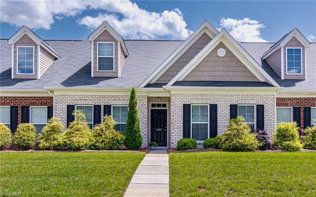 1438 Crestlawn Trl, Pfafftown, NC 27040 - new england style home featuring a front yard, brick siding, and roof with shingles